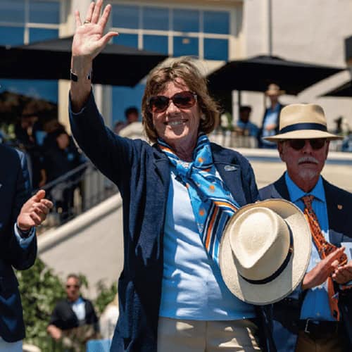 Judge Lyn St. James waves to the crowd Pebble Beach Concours